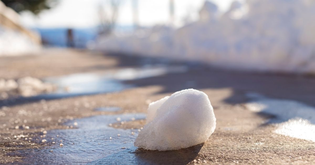 Snowball melting on pavement